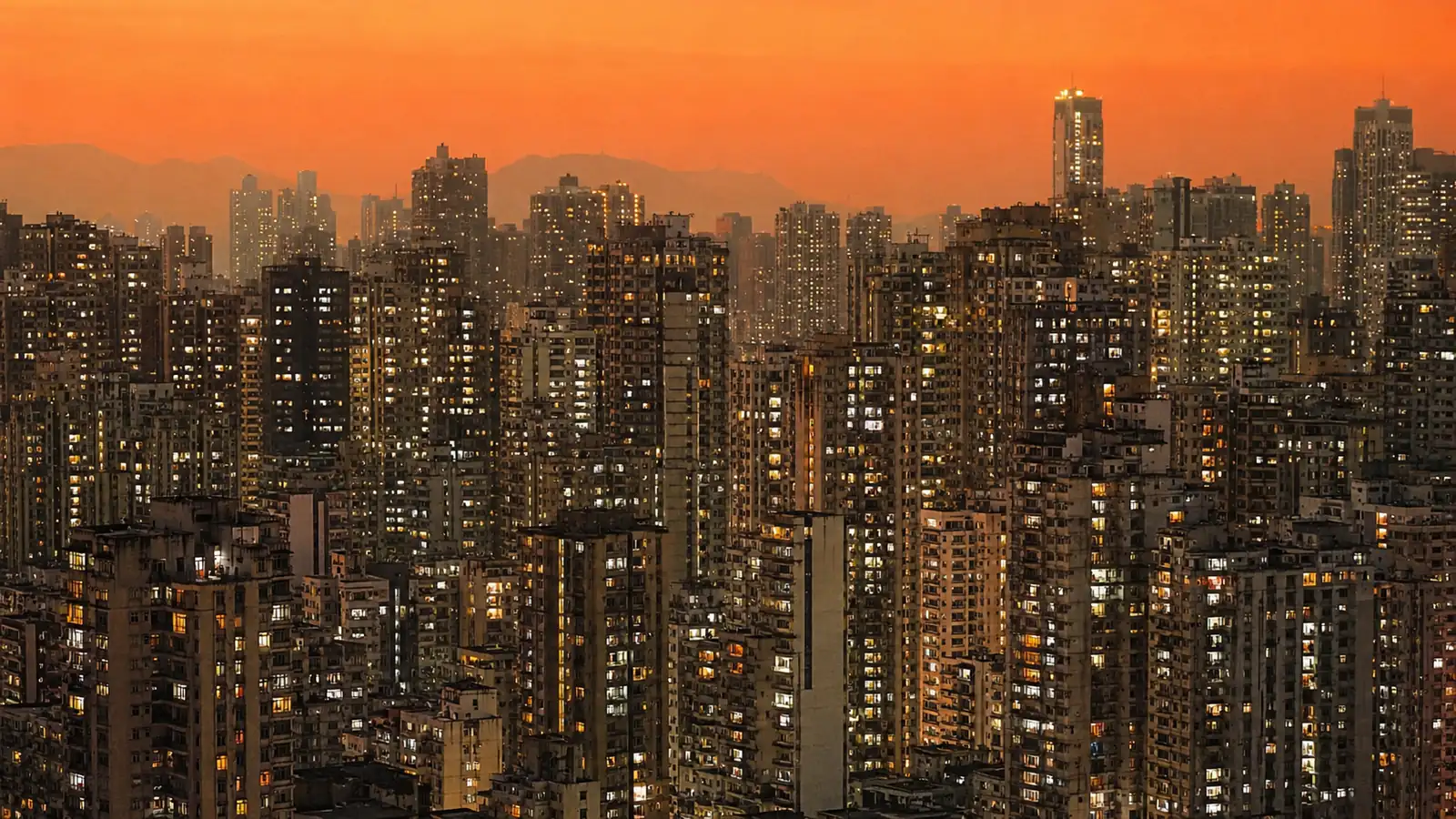 Apartment towers at summer dusk — hundreds of lit windows and AC units