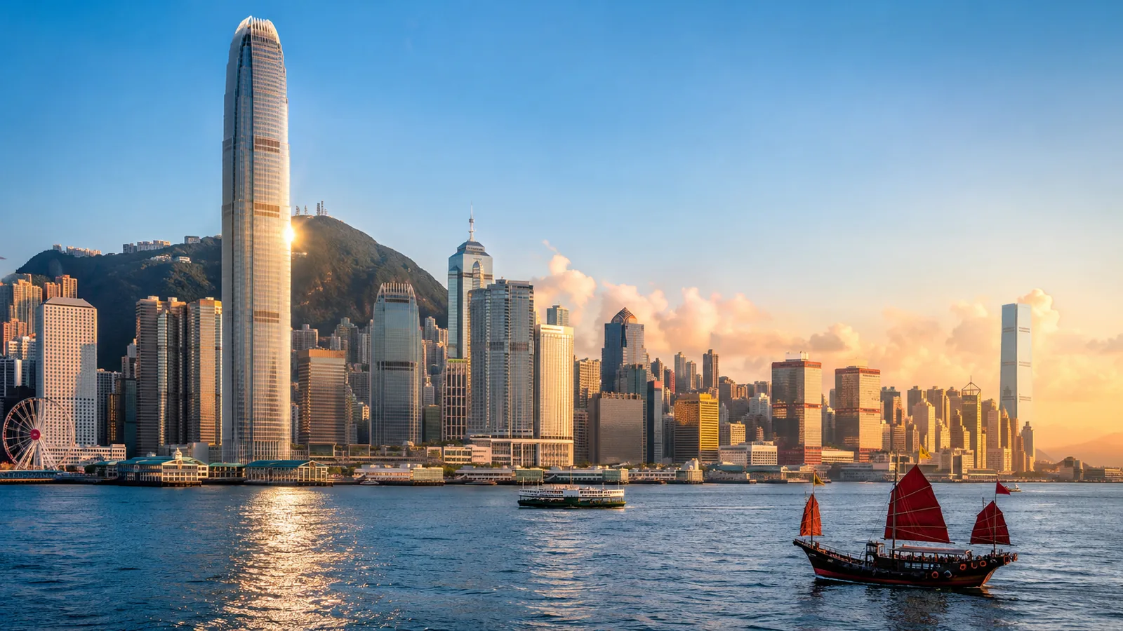 A sunlit East Asian harbour skyline in late afternoon, with modern towers and distant boats